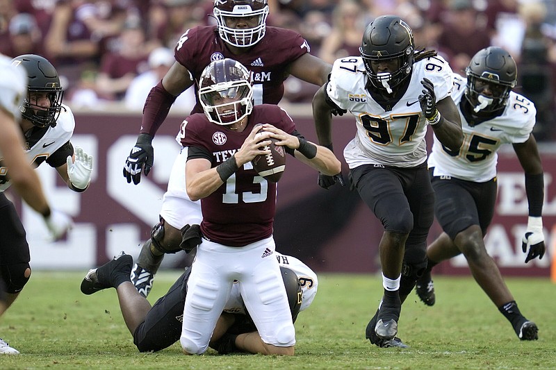 Texas A&M quarterback Haynes King (left) is tackled during the Aggies’ 17-14 loss to Appalachian State on Sept. 10. The Aggies host Miami today at Kyle Field in College Station, Texas.
(AP/Sam Craft)