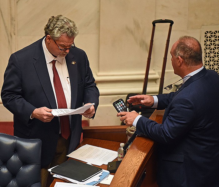 Sen. Alan Clark (left) talks with Senate President Pro Tempore Jimmy Hickey before the start of the Senate session Friday at the State Capitol. After the Senate recessed, Hickey said he doesn’t know when he will reconvene for consideration of the punishment recommended for Clark.
(Arkansas Democrat-Gazette/Staci Vandagriff)
