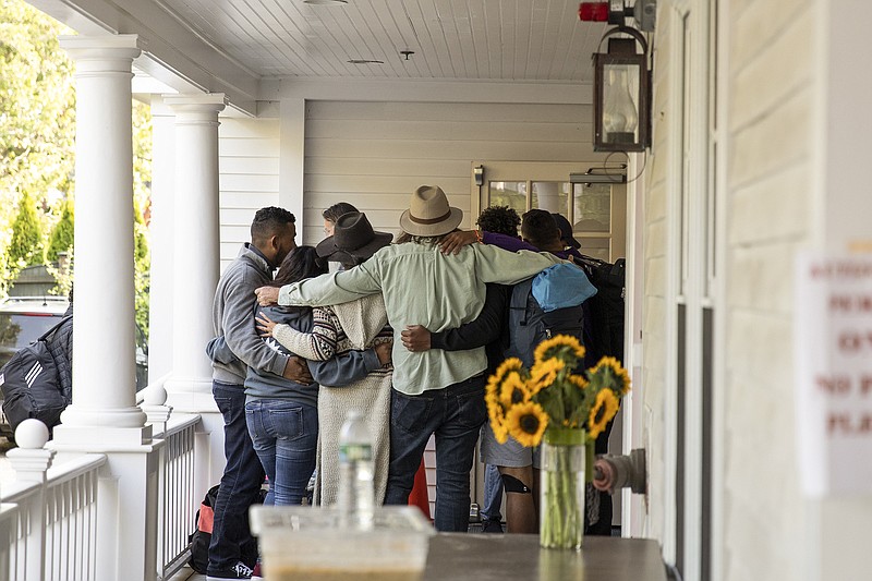 Migrant families bid farewell to volunteers Friday on Martha’s Vineyard in Edgartown, Mass., before boarding a bus that will take them to a ferry.
(The New York Times/Matt Cosby)