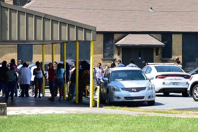 Watson Chapel Junior High students and guardians exit the front entrance of the campus in Pine Bluff on Friday, Sept. 16, 2022. The school released students early after a text message to 911 that authorities called a prank. (Pine Bluff Commercial/I.C. Murrell)