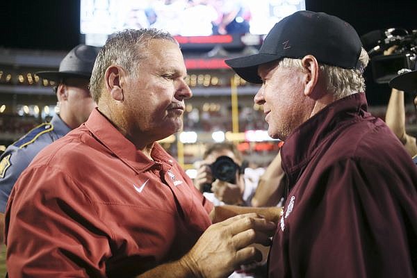Arkansas head coach Sam Pittman greets Missouri State head coach Bobby Petrino, Saturday, September 17, 2022 during the fourth quarter of a football game at Donald W. Reynolds Razorback Stadium in Fayetteville. Visit nwaonline.com/220918Daily/ for today's photo gallery.......(NWA Democrat-Gazette/Charlie Kaijo)