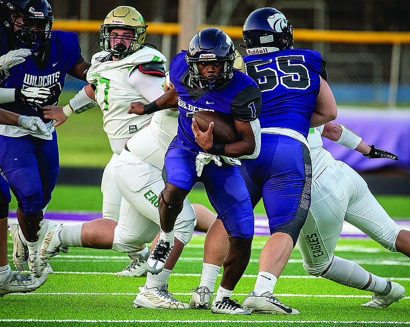 El Dorado's Shadarious Plummer slips through the line for a big running play against Greene County Tech Friday at Memorial Stadium. The Wildcats won 44-6.