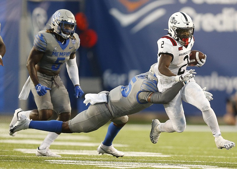 Arkansas State running back Johnnie Lang (2) tries to shake off a Memphis defender during the first quarter Saturday at Simmons Bank Liberty Stadium in Memphis. More photos at arkansasonline.com/918asumem/
(Arkansas Democrat-Gazette/Thomas Metthe)