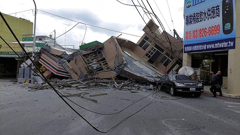 This photo provided by Hualien County fire department show a collapsed residential building following earthquake in Yuli township in Hualien County, eastern Taiwan, Sunday, Sept. 18, 2022. A 7-11 convenience store was at the first floor of the collapse building. (Hualien County Fire Department via AP)