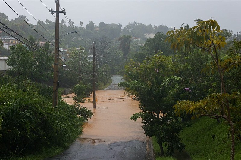 BEST QUALITY AVAILABLE - A road is flooded by the rains of Hurricane Fiona in Cayey, Puerto Rico, Sunday, September 18, 2022. (AP Photo/Stephanie Rojas)