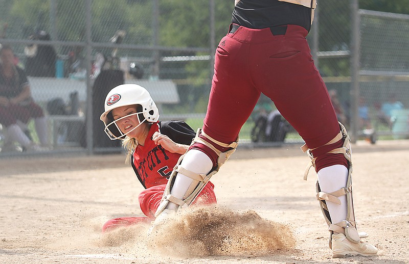 Jefferson City’s Allison Carwile slides safely into home to score a run during Saturday’s game against Lee’s Summit North in the Lady Jays Classic at Binder Park. (Greg Jackson/News Tribune)