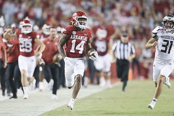 Arkansas punt returner Bryce Stephens (14) runs for a touchdown during a game against Missouri State on Saturday, Sept. 17, 2022, in Fayetteville.