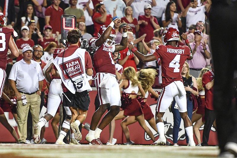 Arkansas quarterback KJ Jefferson (1) celebrates with teammate Malik Hornsby (4), Saturday, Sept. 17, 2022, after Jefferson scored a rushing touchdown during the fourth quarter of the RazorbacksÕ 38-27 win over Missouri State at Donald W. Reynolds Razorback Stadium in Fayetteville. Visit nwaonline.com/220918Daily/ for today's photo gallery..(NWA Democrat-Gazette/Hank Layton)