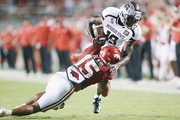 Arkansas defensive back Simeon Blair (15) tackles Missouri State wide receiver Ty Scott (19), Saturday, September 17, 2022 during the fourth quarter of a football game at Donald W. Reynolds Razorback Stadium in Fayetteville.