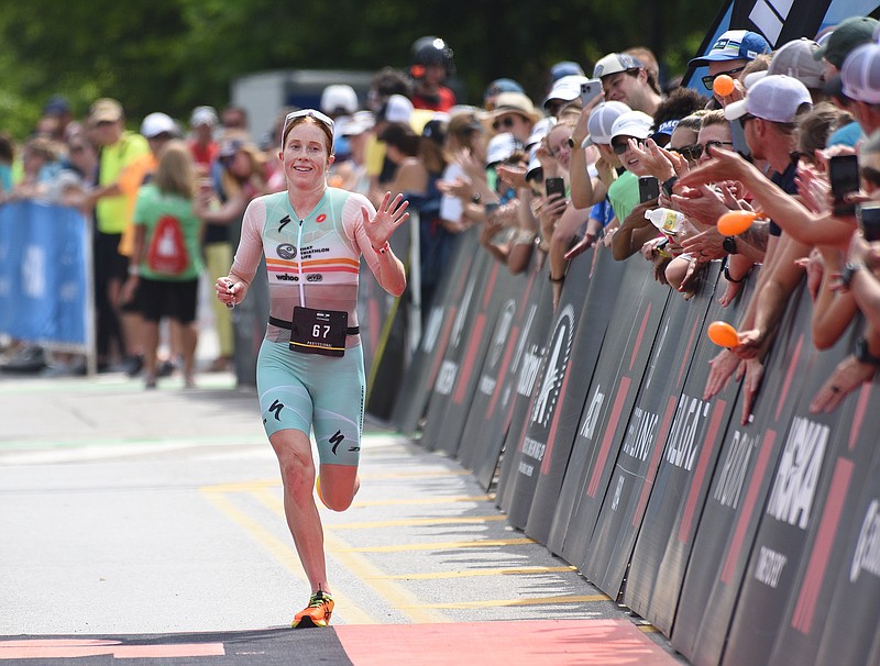 Staff Photo by Matt Hamilton / Crowds cheer as Paula Findlay finishes second for women in the 2022 Sundbelt Bakery Ironman along Riverfront Parkway in Chattanooga on Sunday, May 22, 2022.