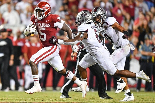 Arkansas running back Raheim Sanders (5) eludes Missouri State defenders Kyriq McDonald (6) and Dillon Thomas (9) to score a rushing touchdown, Saturday, Sept. 17, 2022, during the fourth quarter of the Razorbacks’ 38-27 win over Missouri State at Donald W. Reynolds Razorback Stadium in Fayetteville.