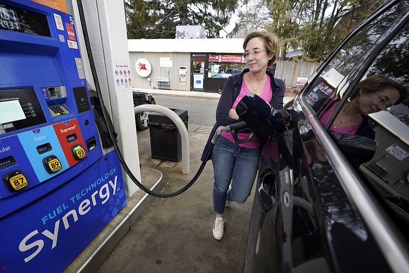 FILE - Jennifer Quinn fills her SUV at a gas station Monday, March 7, 2022, in Needham, Mass. The average price of regular gasoline nationwide is up slightly Wednesday, Sept. 21, from a day earlier, the first time prices have climbed in 99 days. (AP Photo/Steven Senne)