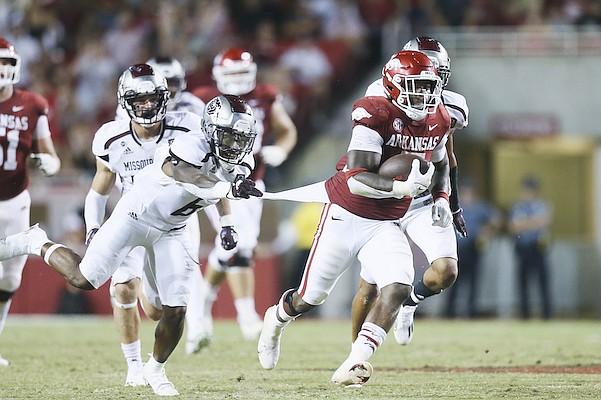 Arkansas running back Raheim Sanders (5) pulls away from Missouri State defenders for a touchdown during the fourth quarter of a game Saturday, Sept. 17, 2022, in Fayetteville.