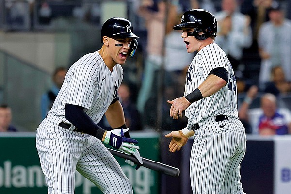 The New York Yankees celebrate after Giancarlo Stanton hit a grand slam  home run in the 9th inning to give the Yankees a 9-8 victory over the  Pittsburgh Pirates at Yankee Stadium