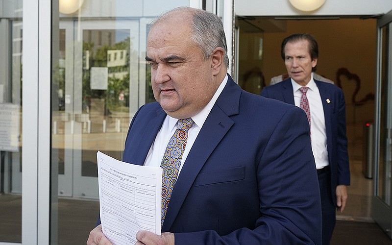 John Davis, former head of the Mississippi Department of Human Services, leaves federal court Thursday in Jackson, Miss., followed by his attorney Merrida Coxwell, after entering his guilty plea.
(AP/Rogelio V. Solis)