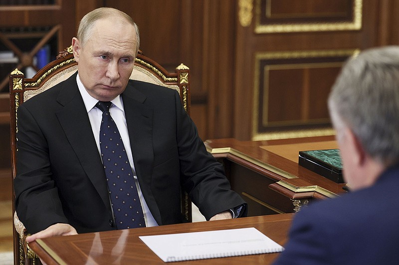 Russian President Vladimir Putin meets Thursday at the Kremlin with Vitaly Mutko, chief executive officer of a state-owned company involved in the mortgage and realty market, as draft notices went out to hundreds of thousands of civilians.
(AP/Sputnik/Gavriil Grigorov)