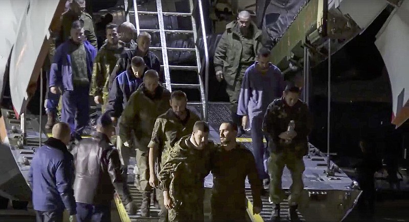 Russian war prisoners walk off a military plane Thursday at an unspecified location in Russia after they were released in a prisoner exchange with Ukraine.
(AP/Russian Defense Ministry Press Service)