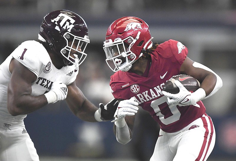 Arkansas running back AJ Green (right) runs for a touchdown as Texas A&M linebacker Aaron Hansford defends during last season;s game. The Razorbacks seek their second consecutive victory over the Aggies when the teams square off at 6 p.m. today at AT&T Stadium in Arlington, Texas.
(NWA Democrat-Gazette/Charlie Kaijo)