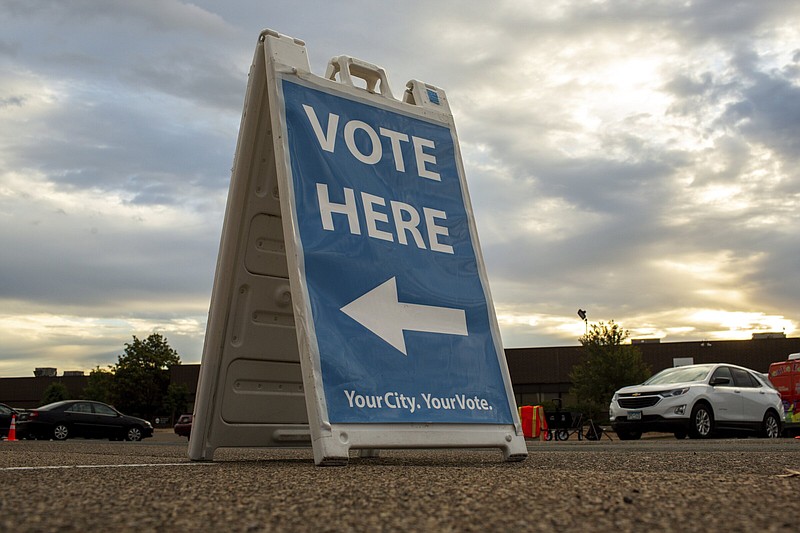 Voting signs direct voters to the Minneapolis Elections and Voter Services center on Friday in Minneapolis. With Election Day still more than six weeks off, the first votes of the midterm election were already being cast Friday in a smattering of states, including Minnesota.
(AP/Nicole Neri)