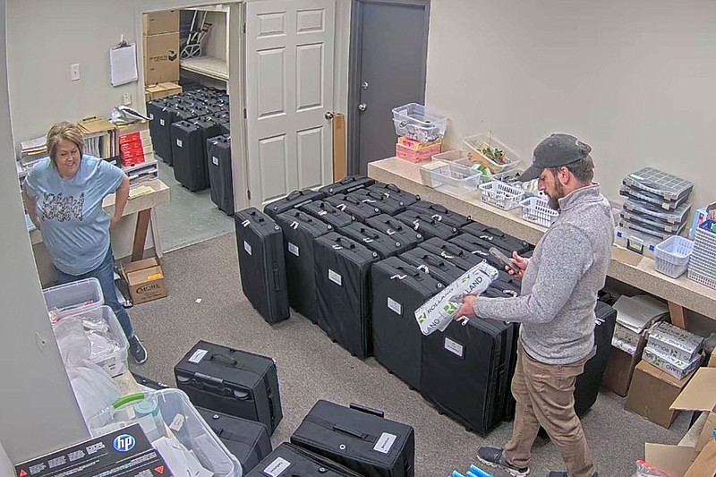 This image from the Coffee County, Ga., Elections Office shows unidentified people around voting equipment in a storage room at the elections office after the 2020 election.
(The New York Times/Coffee County Elections Office)