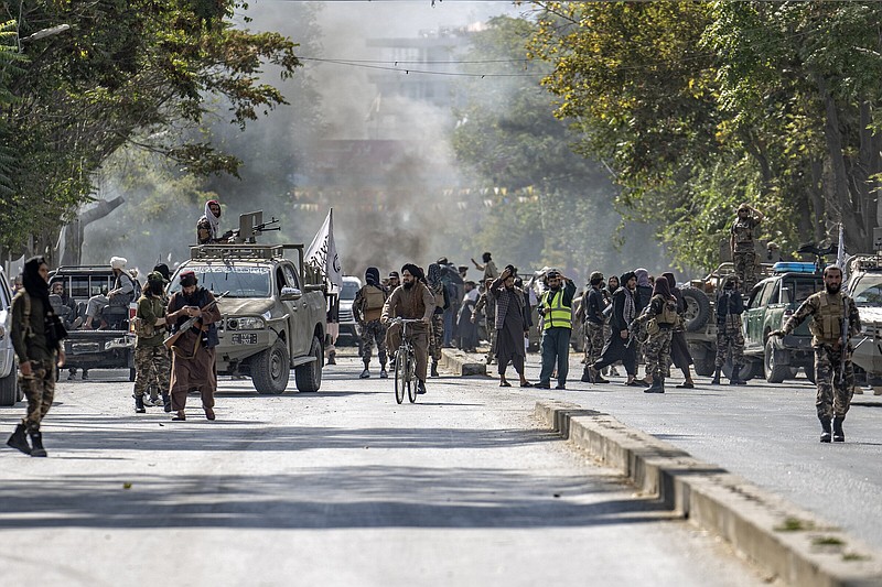 Taliban fighters stand guard at an explosion site Friday near a mosque, in Kabul, Afghanistan.
(AP/Ebrahim Noroozi)