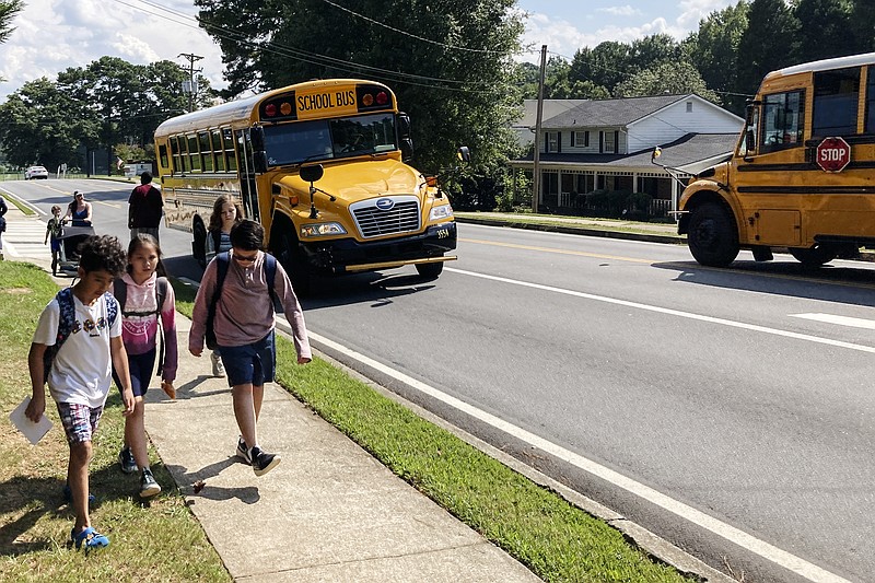 Children walk home from Camp Creek Elementary School in Lilburn, Ga., after school on Monday, Sept. 12, 2022. (AP Photo/Jeff Amy)