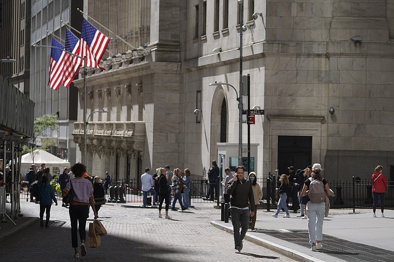 Visitors to the financial district walk past the New York Stock Exchange, Friday, Sept. 23, 2022, in New York. (AP Photo/Mary Altaffer)