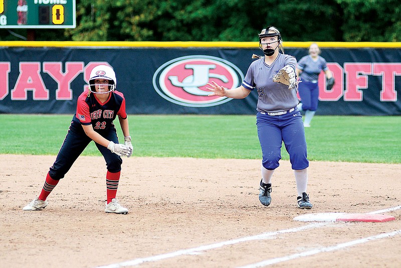 Kyra Meyer of Jefferson City and Russellville first baseman K’Lea Basnett look toward the plate during Thursday’s game at Vogel Field. (Eileen Wisniowicz/News Tribune)