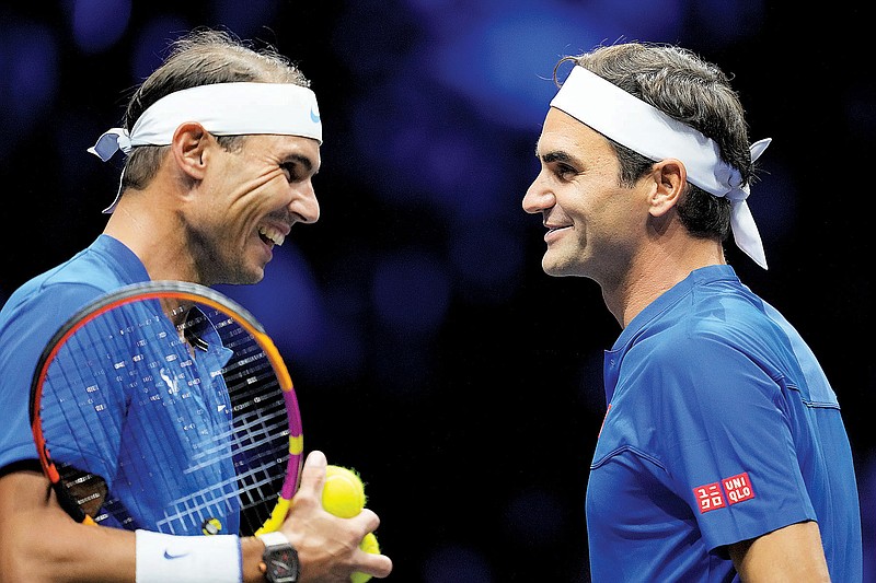 Roger Federer (right) and Rafael Nadal react Friday during their Laver Cup doubles match against Jack Sock and Frances Tiafoe at the O2 arena in London. (Associated Press)