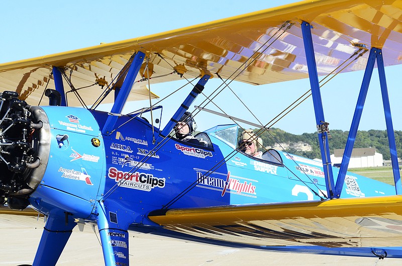 Eileen Wisniowicz/News Tribune photo: Brian Schmidt, left, takes a ride with pilot Darryl Fischer on Saturday, Sept. 24, 2022, at Jefferson City Memorial Airport. Fischer is part of Dream Flights an organization that takes military veterans on rides in Boeing Stearman biplanes. After the ride, Schmidt said that it had been a dream to fly in one and that he has a "permament grin" now.