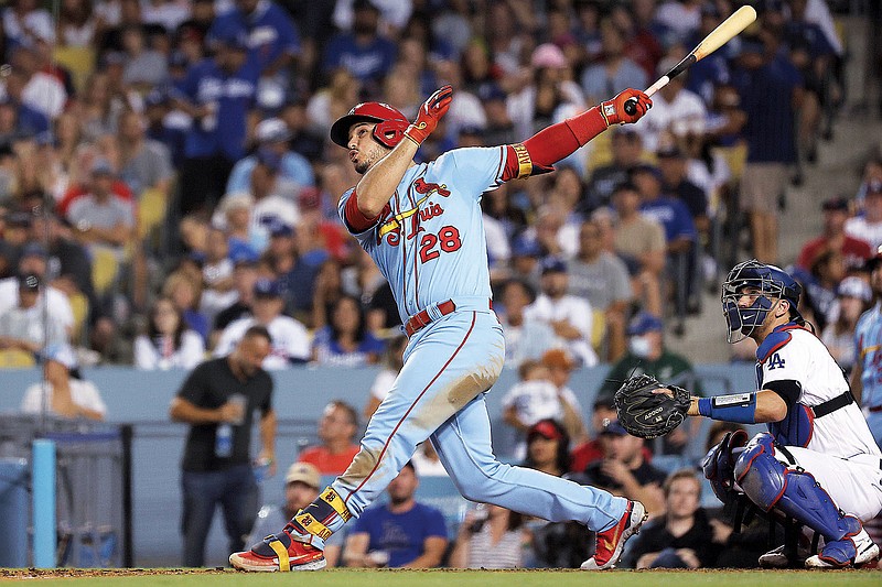 Nolan Arenado of the Cardinals watches his two-run home run next to Dodgers catcher Austin Barnes during the sixth inning of Saturday night's game at Dodger Stadium in Los Angeles. (Associated Press)