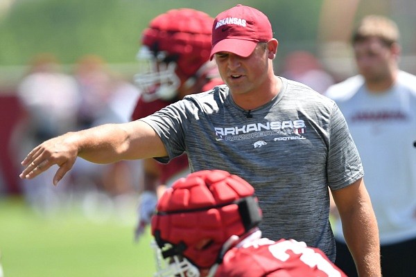 Arkansas linebackers coach Michael Scherer directs his players Thursday, Aug. 11, 2022, during practice at the university practice field.