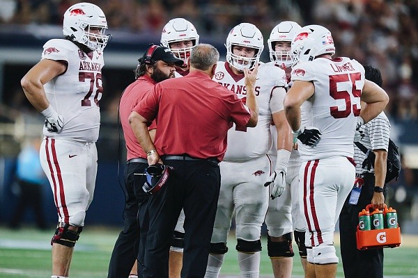 Arkansas head coach Sam Pittman talks to offensive lineman, Saturday, September 23, 2022 during the second quarter of a football game at AT&T Stadium in Arlington, Texas.