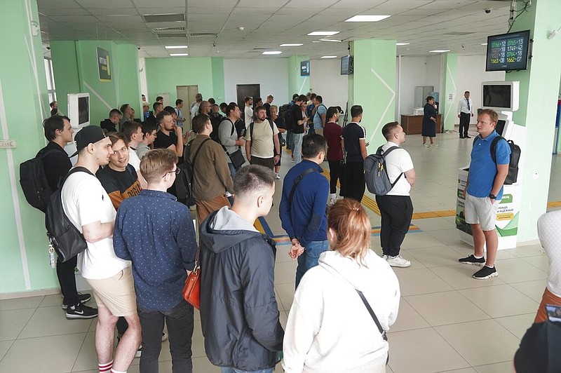 Russians lineup to get Kazakhstan's a Personal Identification Number (INN) in a public service center in Almaty, Kazakhstan, Tuesday, Sept. 27, 2022. (Vladimir Tretyakov/NUR.KZ via AP)
