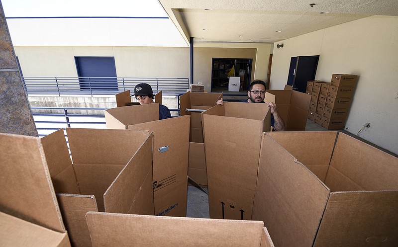 Movers sorts boxes for packing at the Los Angeles Chargers' facility after NFL football minicamp, Thursday, June 15, 2017, in San Diego. Finding a home on and off the field can be an overwhelming chore for many NFL players. Especially in a topsy-turvy league where job security is far from guaranteed. (AP Photo/Denis Poroy, File)