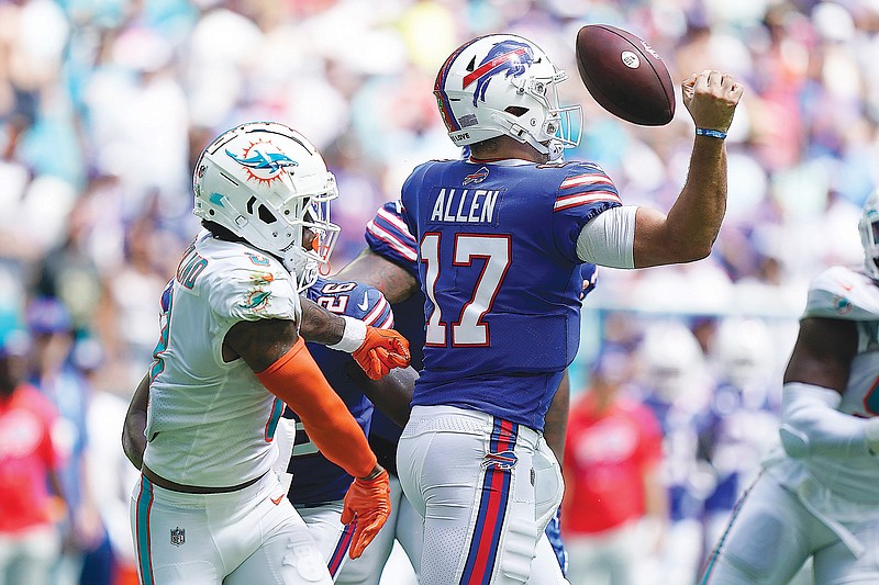 Dolphins safety Jevon Holland causes a fumble by Bills quarterback Josh Allen during the first half of Sunday’s game in Miami Gardens, Fla. (Associated Press)