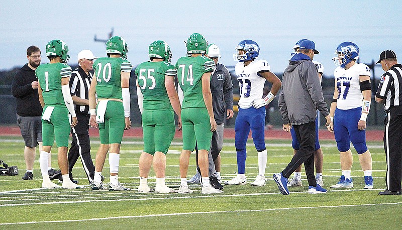 Team captains for Blair Oaks and Boonville meet at midfield for the coin toss prior to Friday night's game at the Falcon Athletic Complex in Wardsville. (Gracen Gaskins/News Tribune)