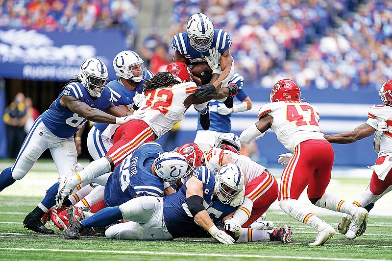 Colts running back Jonathan Taylor is tackled by Chiefs linebacker Nick Bolton on a fourth-down play during the second half of Sunday’s game in Indianapolis. Taylor was stopped short of the first down. (Associated Press)