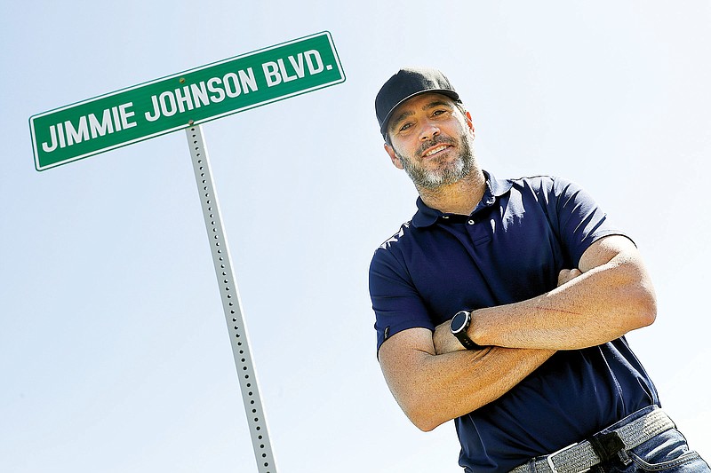 In this July 12, 2020, file photo, Jimmie Johnson poses in front of a street sign after the street was named for him outside Kentucky Speedway in Sparta, Ky. (Associated Press)