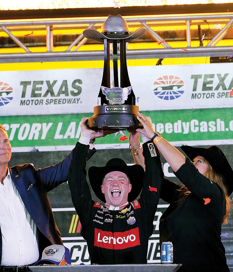Tyler Reddick lifts the winners trophy Sunday night after winning the the NASCAR Cup Series race at Texas Motor Speedway in Fort Worth, Texas. (Associated Press)