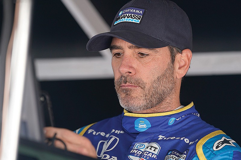 In this May 27 file photo, Jimmie Johnson sits in his pit box before the final practice for the Indianapolis 500 at Indianapolis Motor Speedway in Indianapolis. (Associated Press)