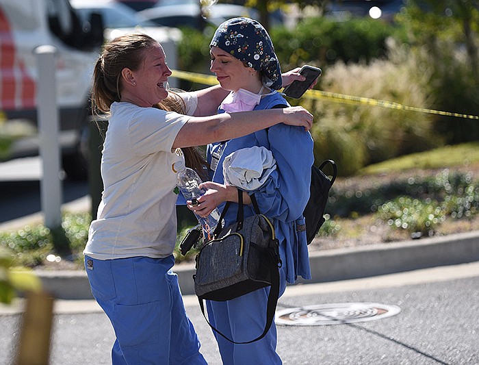 Two women embrace each other as law enforcement officers respond to reports of a gunman Wednesday at CHI St. Vincent North in Sherwood. More photos at arkansasonline.com/929stvincent/.
(Arkansas Democrat-Gazette/Staci Vandagriff)