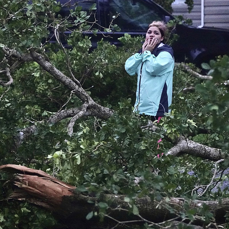 Zuram Rodriguez surveys the damage around her mobile home Wednesday in Davie, Fla. More photos at arkansasonline.com/929ian/
(AP/South Florida Sun-Sentinel/Joe Cavaretta)