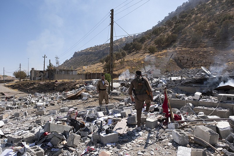 Members of exiled Komala Party inspect the aftermath of Wednesday’s bombing in the village of Zrgoiz, near Sulaimaniyah, Iraq, where the bases of several Iranian opposition groups are located. An Iranian drone bombing campaign targeting the bases of an Iranian-Kurdish opposition group in northern Iraq has killed and wounded dozens.
(AP/Metrography/Ala Hoshyar)