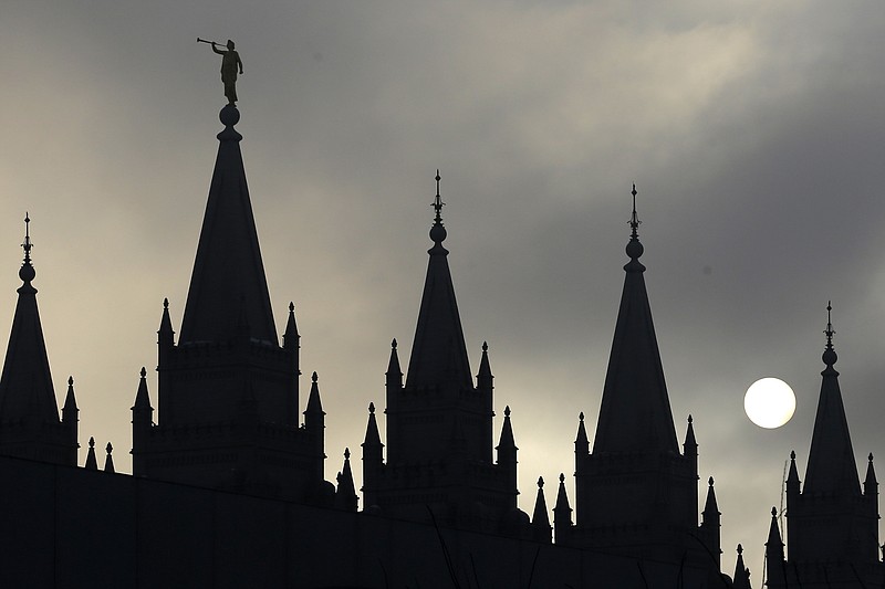 The angel Moroni statue atop the Salt Lake Temple is silhouetted against a cloud-covered sky, at Temple Square in Salt Lake City on Feb. 6, 2013. (AP Photo/Rick Bowmer, File)