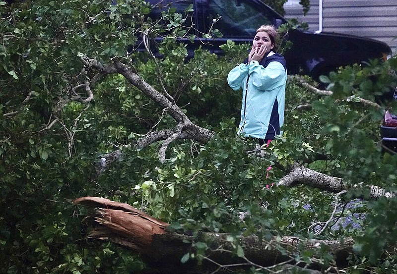 Zuram Rodriguez surveys the damage around her mobile home in Davie, Fla., early Wednesday, Sept. 28, 2022. (Joe Cavaretta/South Florida Sun-Sentinel via AP)