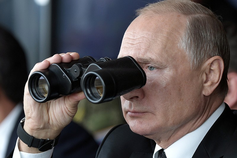 Russian President Vladimir Putin holds binoculars while watching the military exercises Center-2019 at Donguz shooting range near Orenburg, Russia, in Sept. 20, 2019. (Alexei Nikolsky, Sputnik, Kremlin Pool Photo via AP, File)