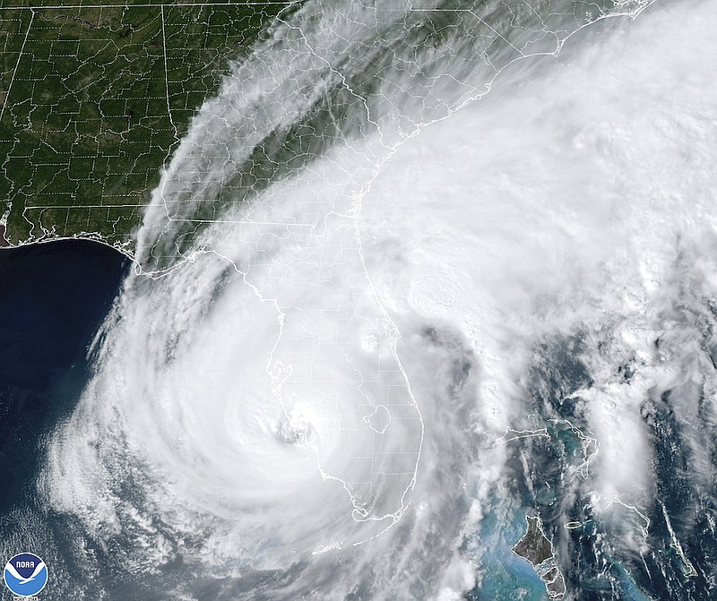 This satellite image taken at 3:06 p.m. EDT and provided by NOAA shows Hurricane Ian making landfall in southwest Florida near Cayo Costa on Wednesday, Sept. 28, 2022, as a catastrophic Category 4 storm. (NOAA via AP)