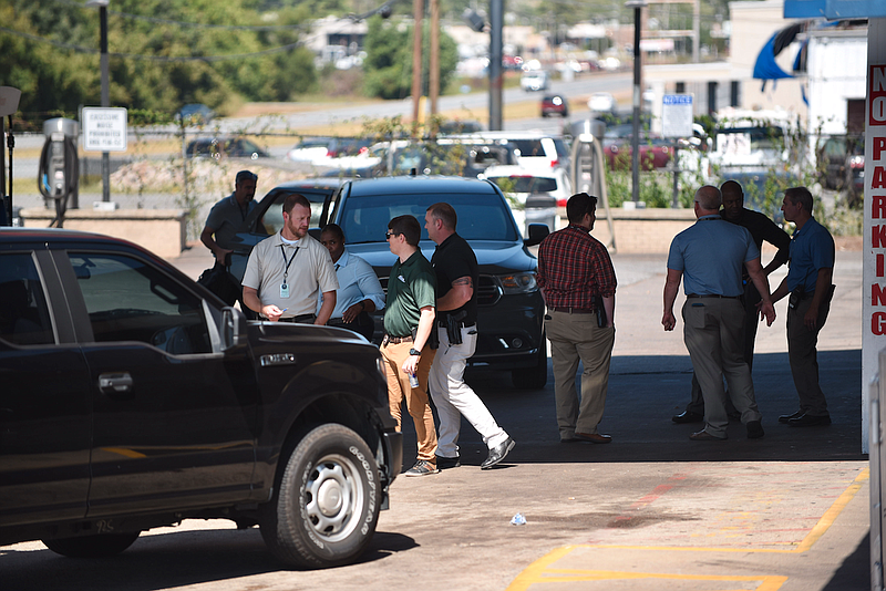 Investigators work at an Zimmerman's Exxon, 5223 S. University Ave. on Wednesday after a man accused in a fatal shooting at CHI St. Vincent North was taken into custody. (Arkansas Democrat-Gazette/Staci Vandagriff)