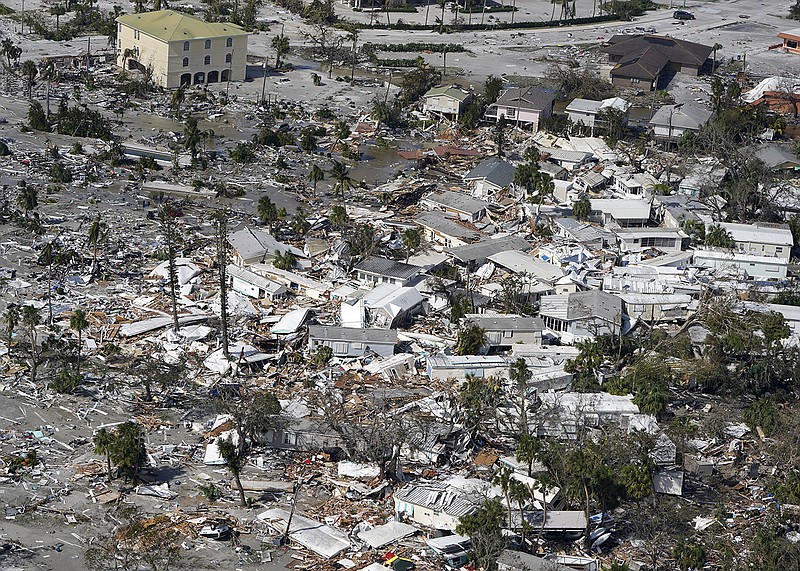 Damaged homes and debris are shown in the aftermath of Hurricane Ian on Thursday in Fort Myers, Fla. More photos at arkansasonline.com/930ian/.
(AP/Wilfredo Lee)